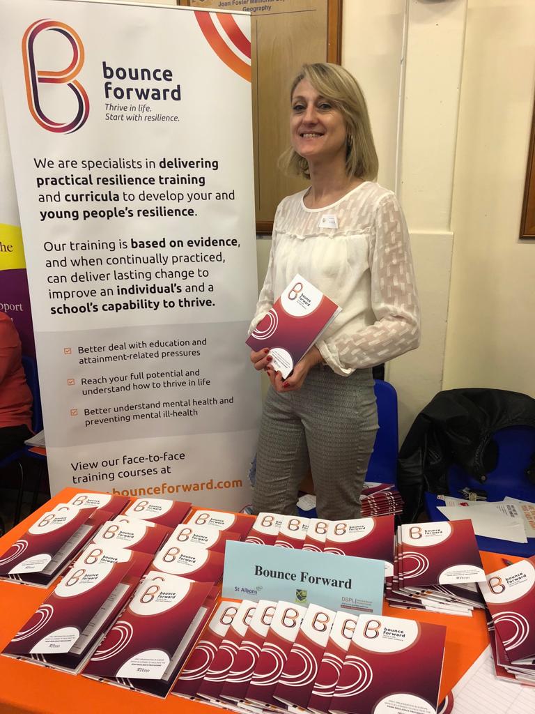 Julie Newbury standing beside a Bounce Forward banner
