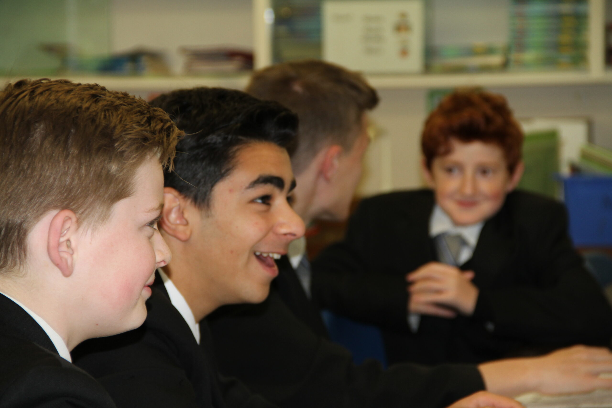 Pupils smiling together in class